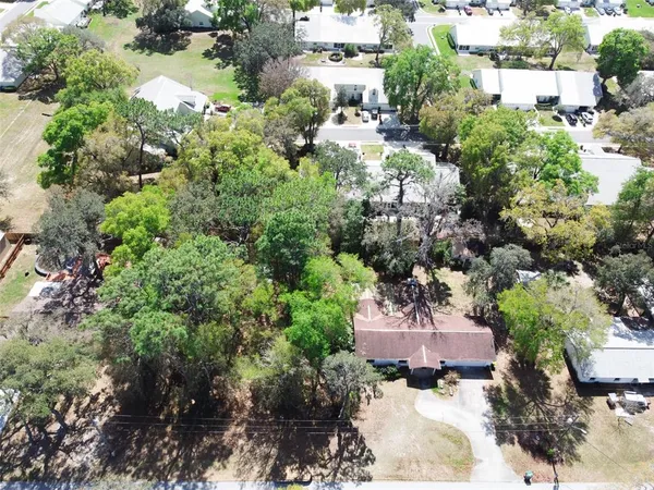 an aerial view of a houses with yard