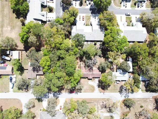 an aerial view of a house with a yard and garden