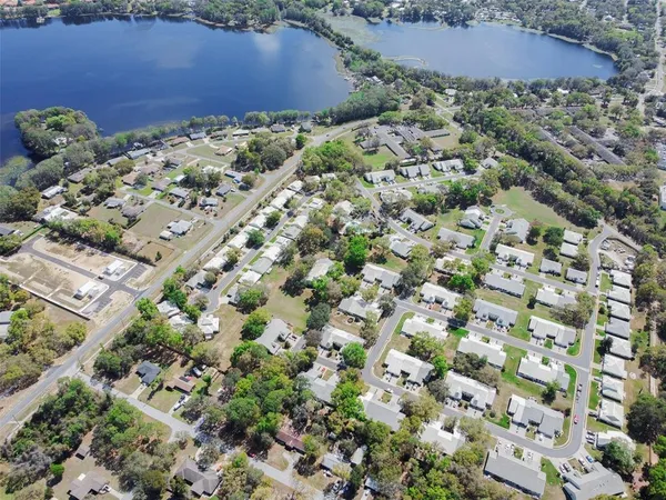 an aerial view of house with yard and mountain view in back