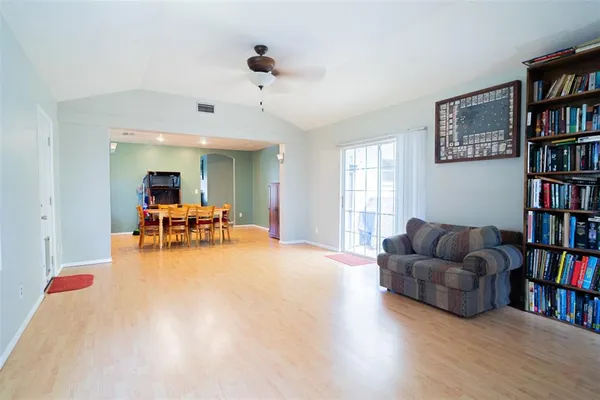 a living room with furniture and a book shelf