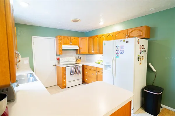 a kitchen with a refrigerator and a sink