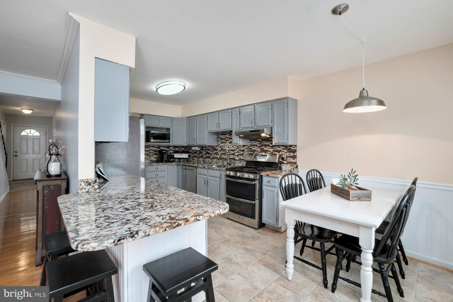 1617 Cape May Road Baltimore, MD 21221 - Photo 2 of 37 a kitchen with a table and chairs in it