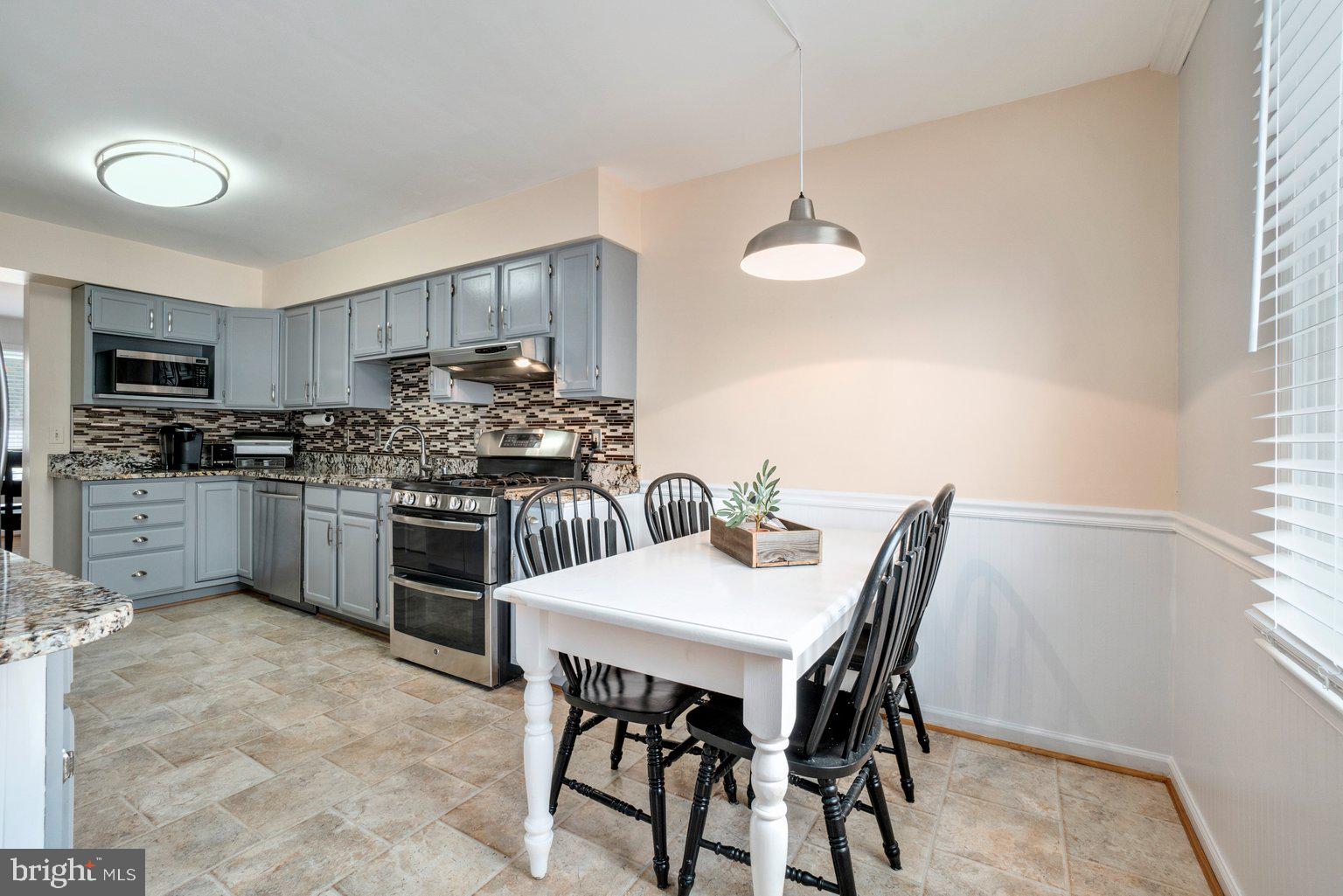 1617 Cape May Road Baltimore, MD 21221 - Photo 11 of 37 a kitchen with a table and chairs in it