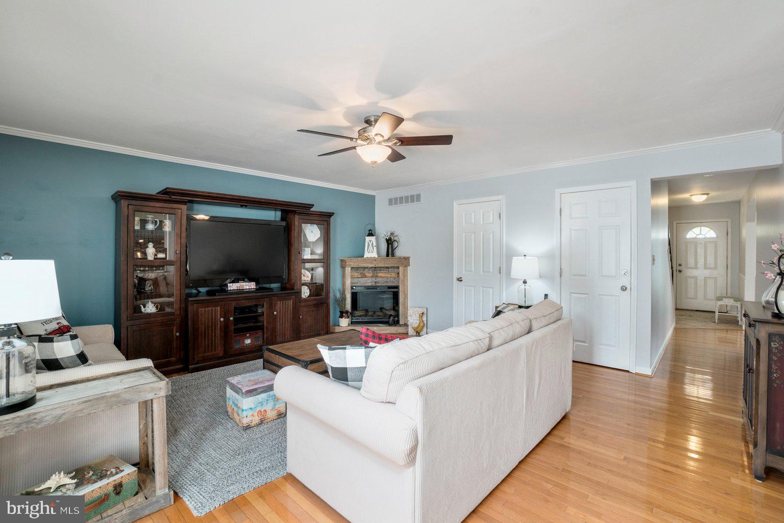 1617 Cape May Road Baltimore, MD 21221 - Photo 13 of 37 a living room with furniture a flat screen tv and a fireplace