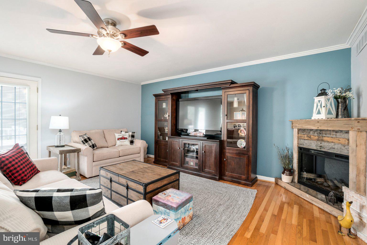 1617 Cape May Road Baltimore, MD 21221 - Photo 3 of 37 a living room with furniture a flat screen tv and a fireplace