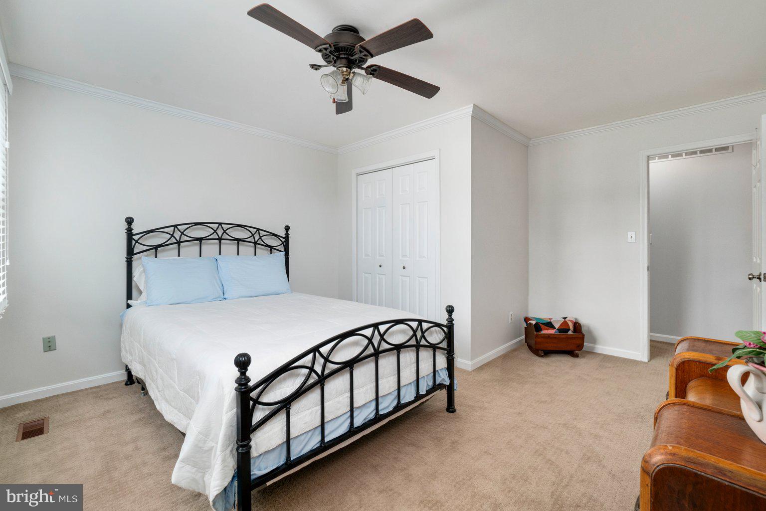 1617 Cape May Road Baltimore, MD 21221 - Photo 28 of 37 a bedroom with a bed and a chandelier