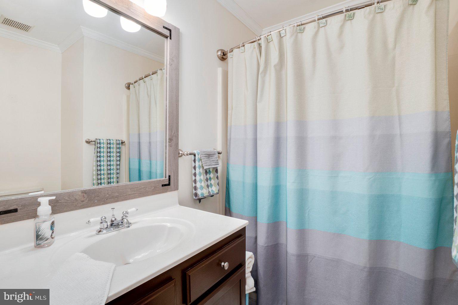1617 Cape May Road Baltimore, MD 21221 - Photo 31 of 37 a bathroom with a sink and a mirror