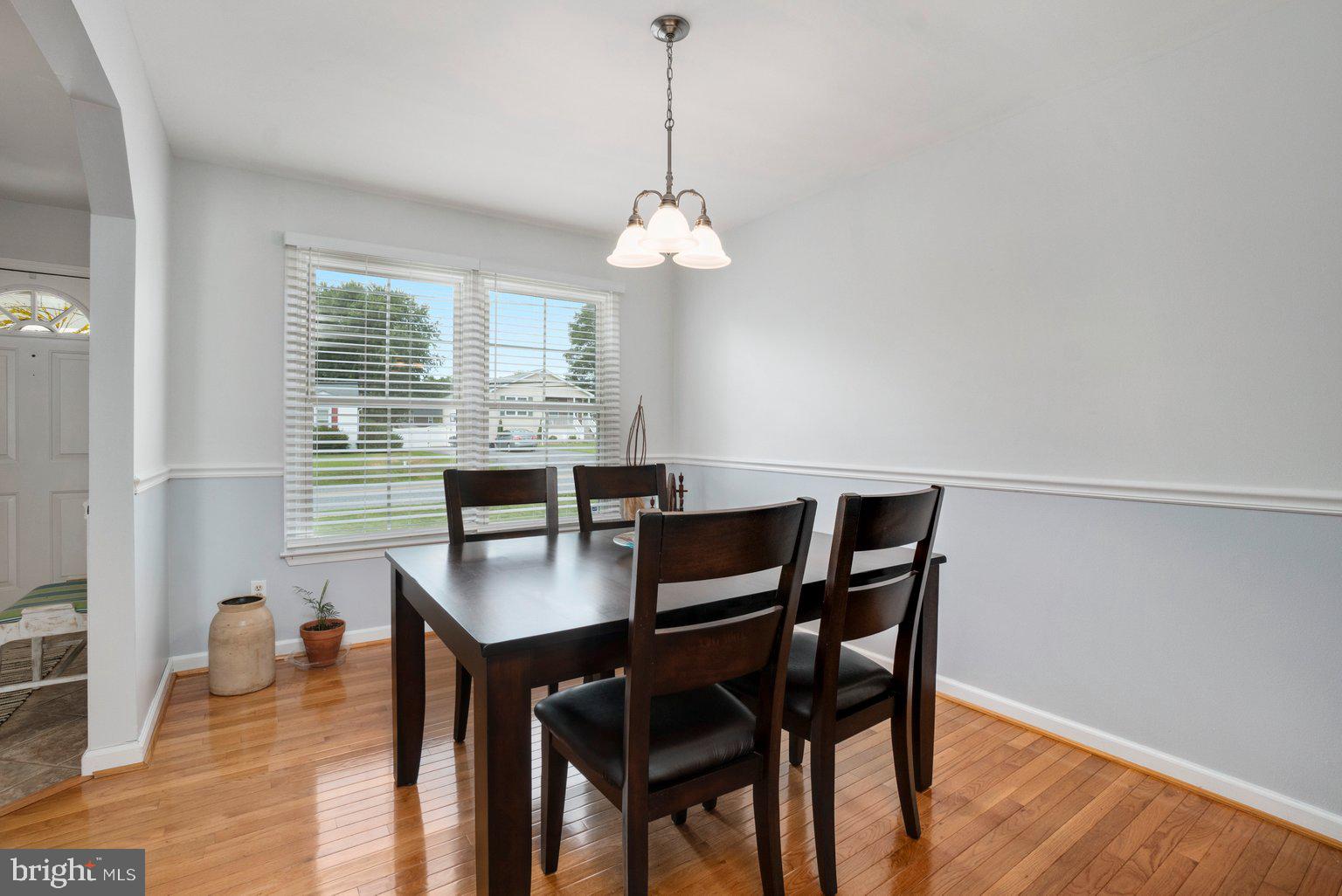 1617 Cape May Road Baltimore, MD 21221 - Photo 8 of 37 a dining room with furniture a chandelier and wooden floor