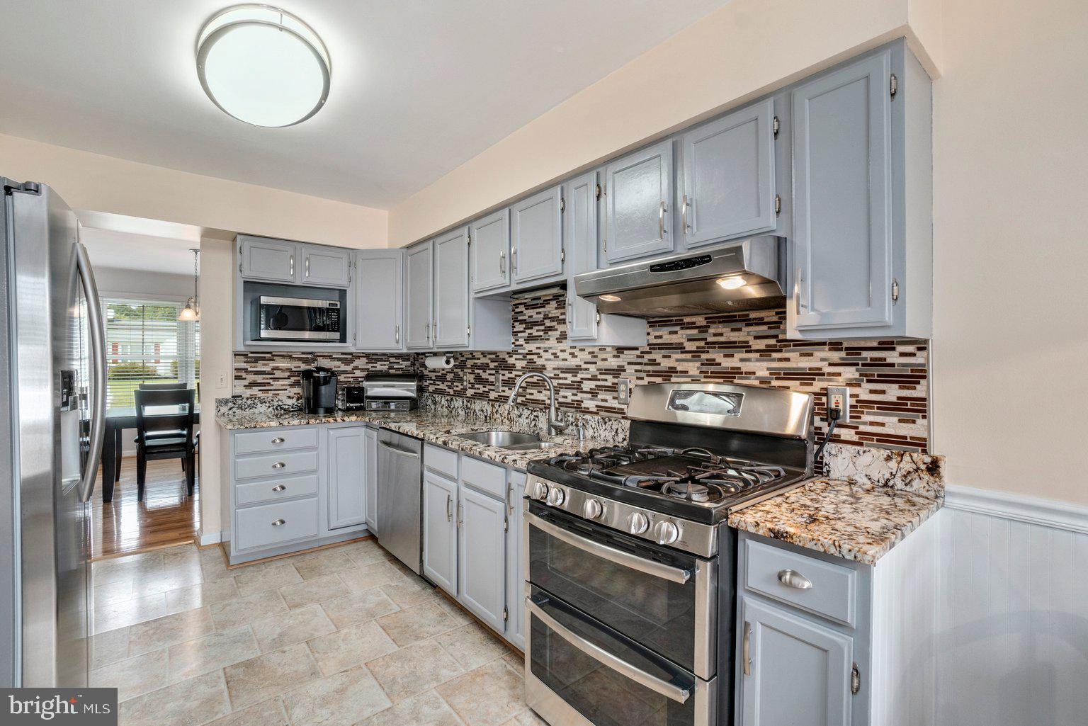 1617 Cape May Road Baltimore, MD 21221 - Photo 9 of 37 a kitchen with granite countertop a stove and a sink