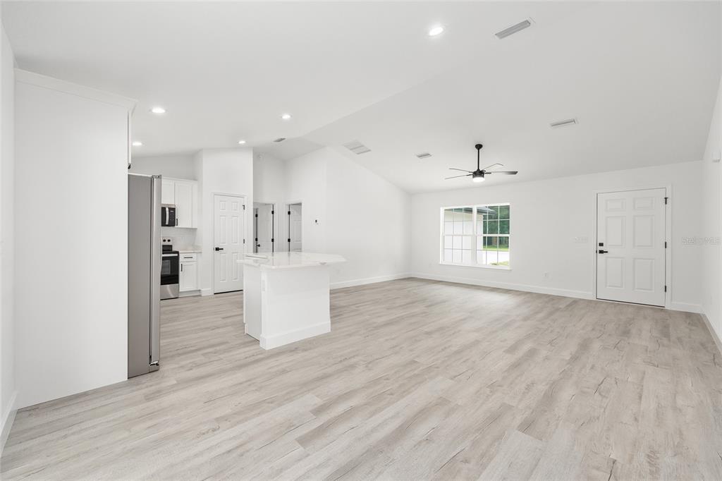 6052 Northwest 53rd Street Road Ocala, FL 34482 - Photo 16 of 26 an empty room with wooden floor and windows