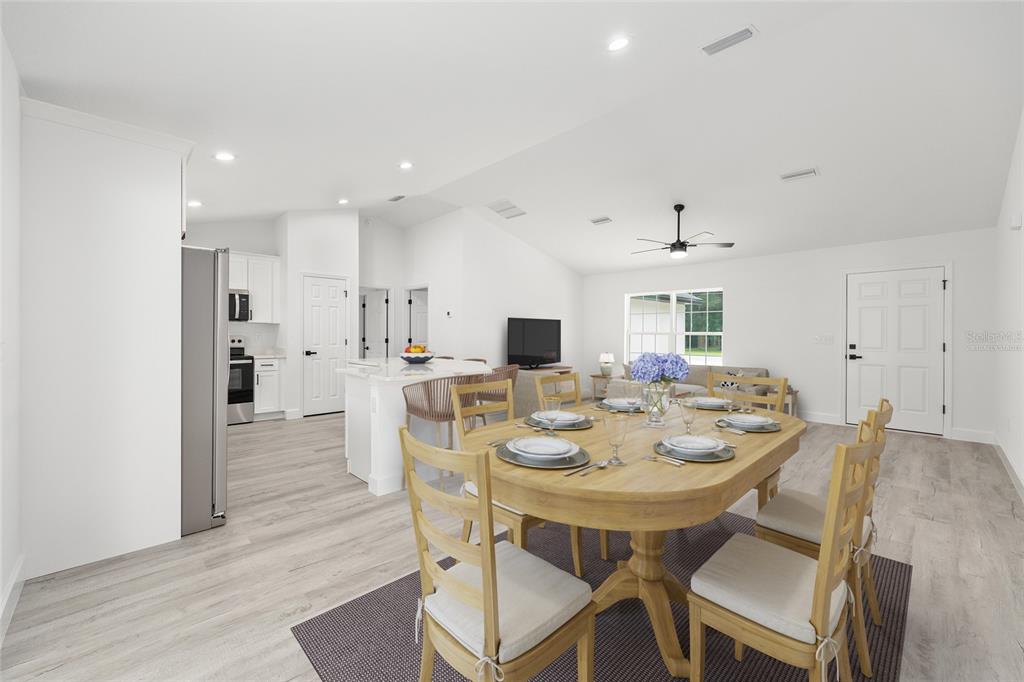 6052 Northwest 53rd Street Road Ocala, FL 34482 - Photo 4 of 26 a view of a dining room with furniture and wooden floor