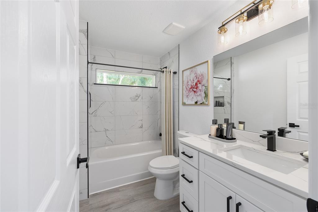 6052 Northwest 53rd Street Road Ocala, FL 34482 - Photo 8 of 26 a bathroom with a sink a toilet and shower