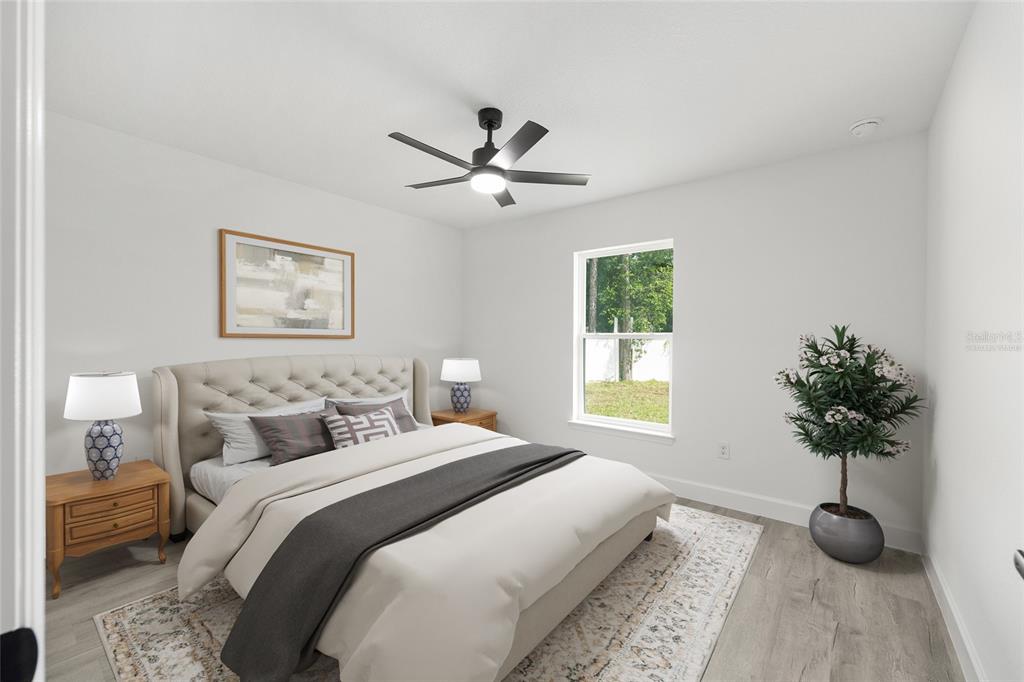 6052 Northwest 53rd Street Road Ocala, FL 34482 - Photo 9 of 26 a bedroom with a bed and a potted plant