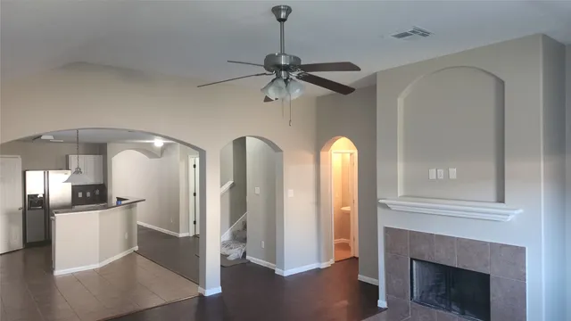 a view of a kitchen with a sink a refrigerator a fireplace and wooden floor