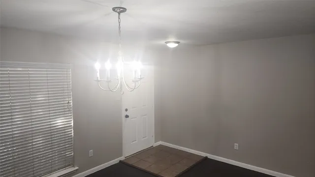 a view of a room with wooden floor and fan