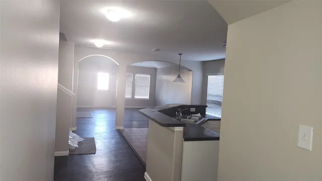 a kitchen with stainless steel appliances granite countertop a sink stove and cabinets
