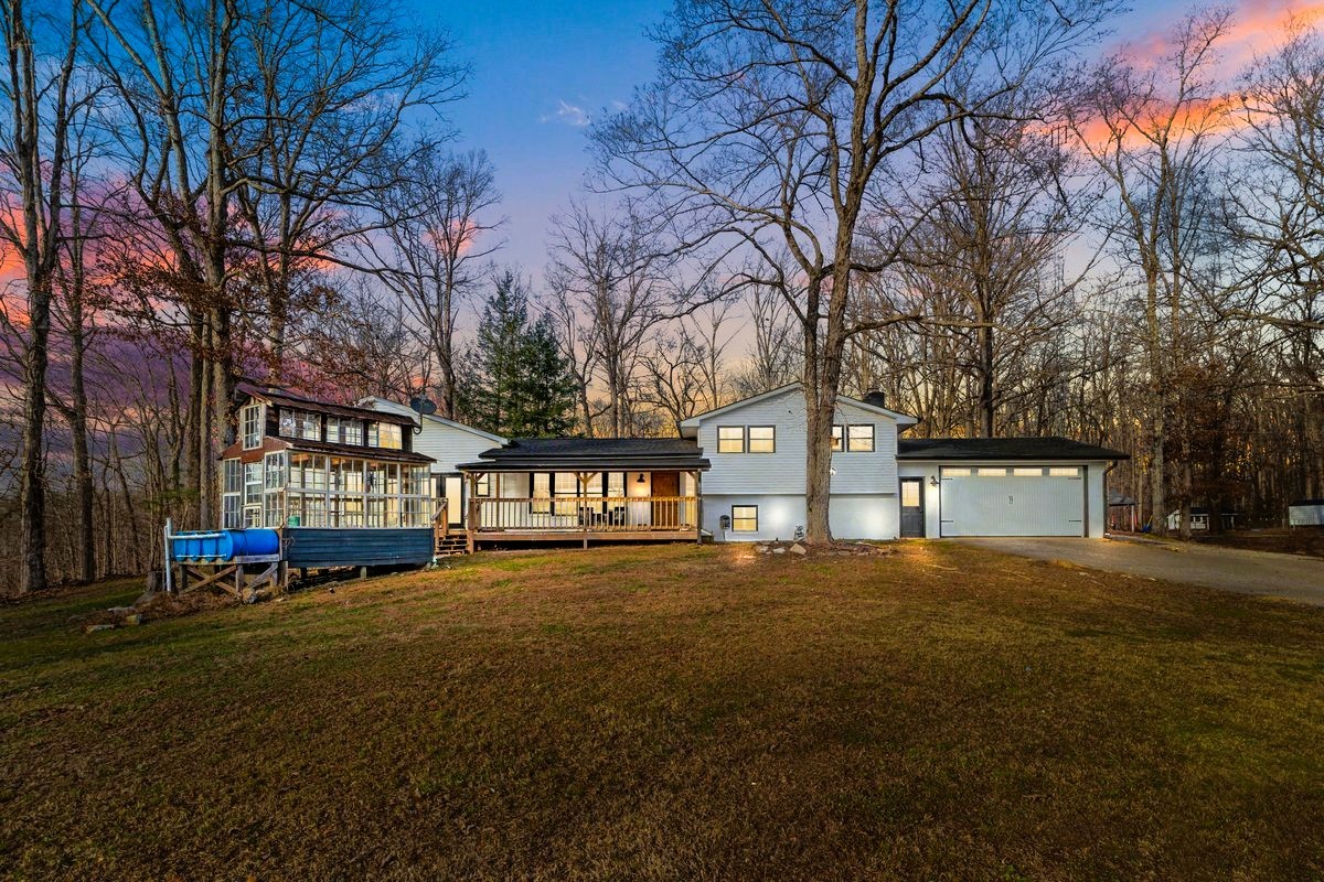 1975 Kelly Road Holladay, TN 38341 - Photo 1 of 88 a front view of a house with a yard and trees
