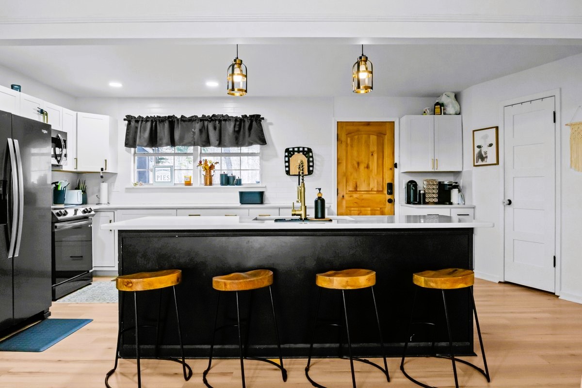 1975 Kelly Road Holladay, TN 38341 - Photo 14 of 88 a kitchen with stainless steel appliances a dining table chairs refrigerator and sink