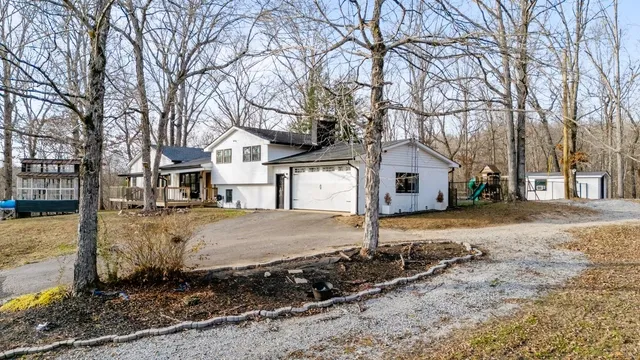 a view of a house with a snow in front of yard
