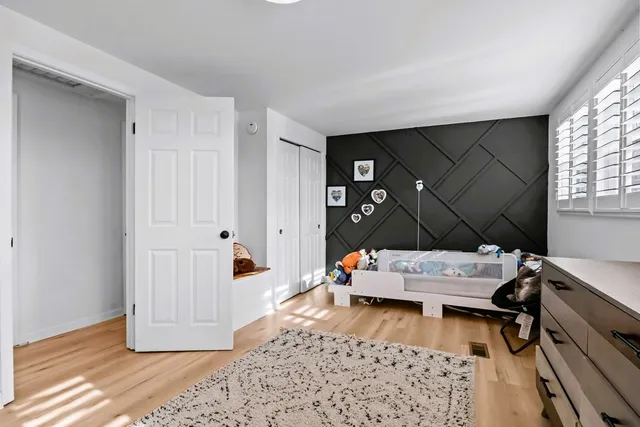 a room with gym equipment and wooden floor