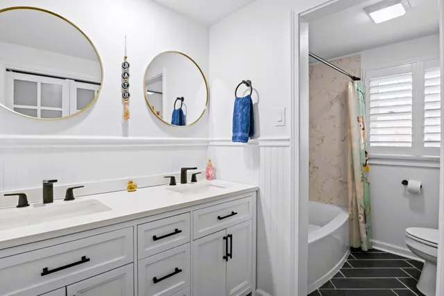 a view of a room with wooden floor and furniture