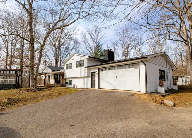 a front view of house with yard barbeque and outdoor seating