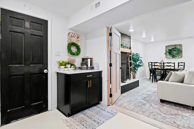 a living room with furniture a flat screen tv and a wall painting