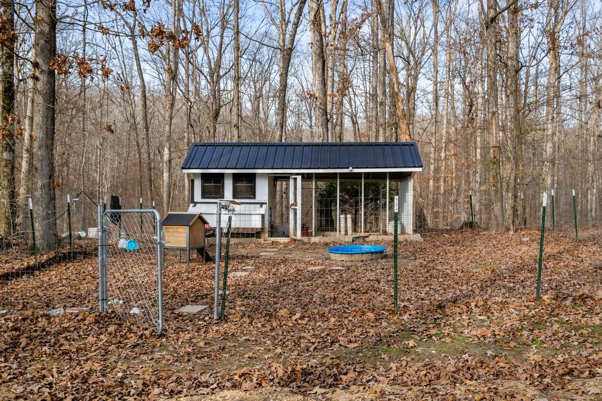 1975 Kelly Road Holladay, TN 38341 - Photo 66 of 88 a front view of a house with a yard and chairs