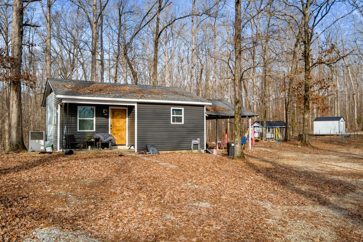 1975 Kelly Road Holladay, TN 38341 - Photo 69 of 88 a front view of a house with a yard and seating space