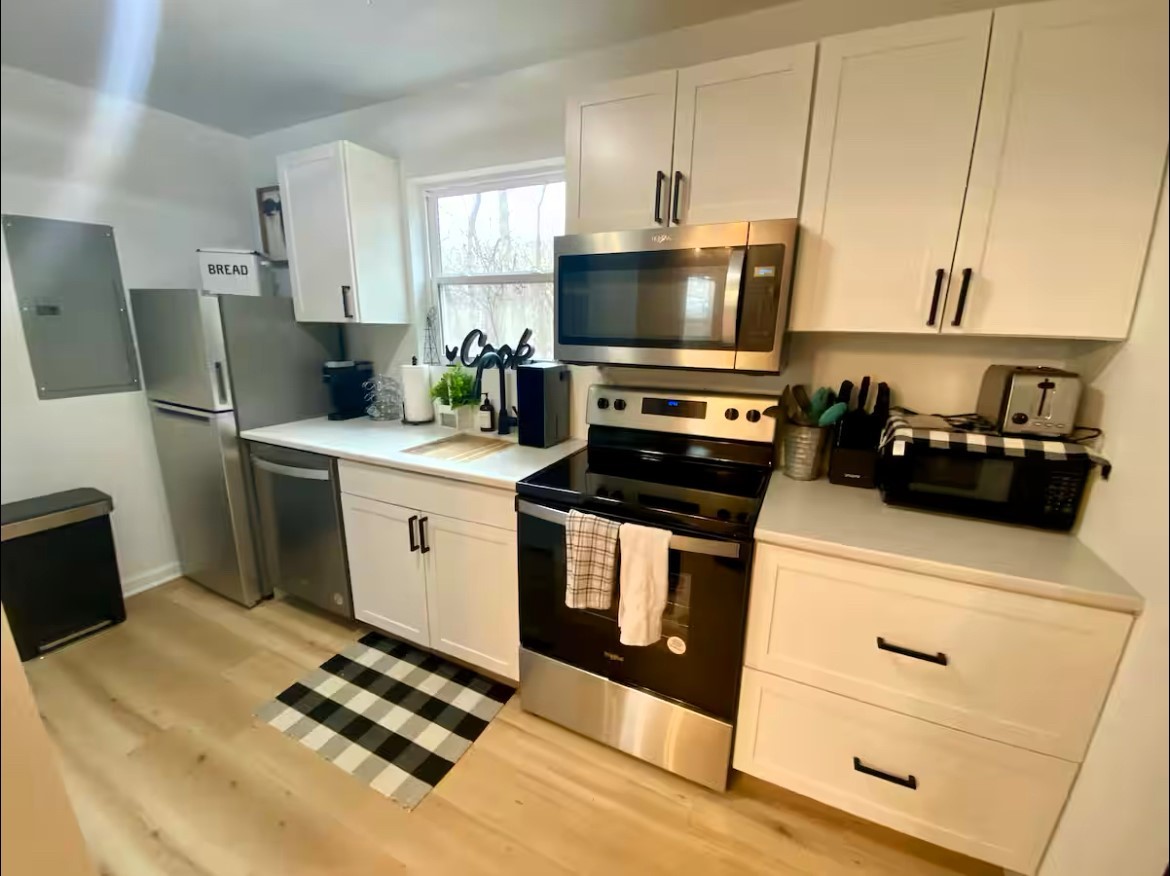 1975 Kelly Road Holladay, TN 38341 - Photo 74 of 88 a kitchen with stainless steel appliances a stove a microwave and a refrigerator