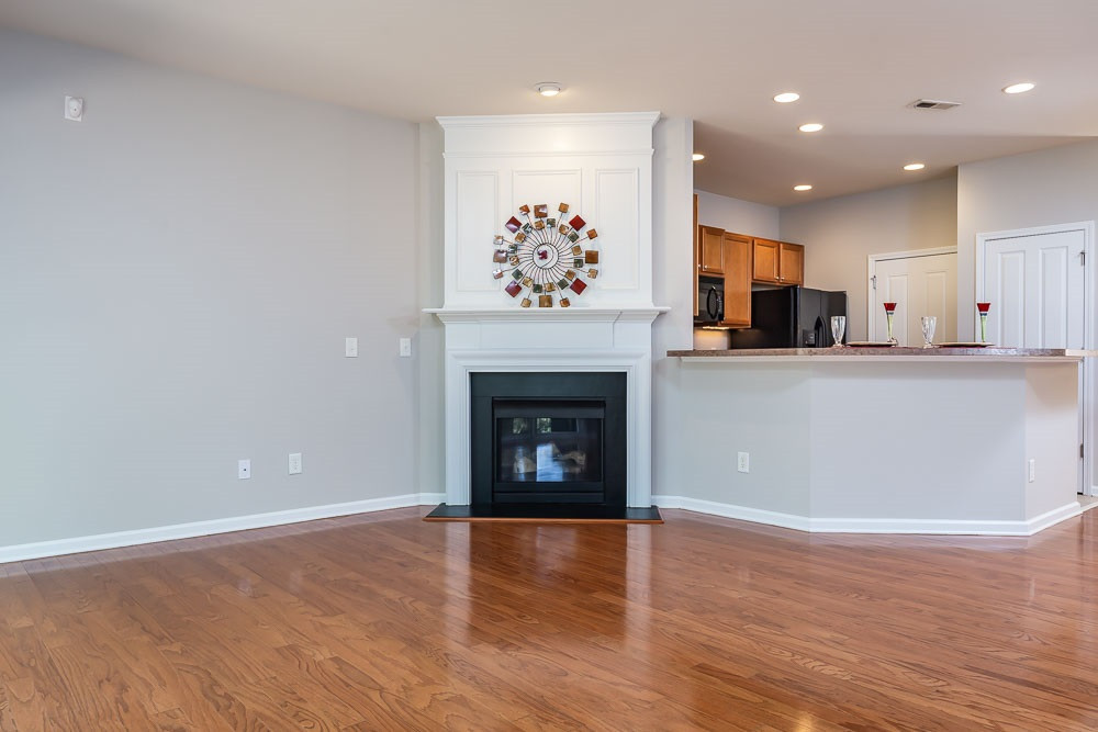 8722 Owl Roost Place Raleigh, NC 27617 - Photo 7 of 26 Cozy corner fireplace leaves a spacious wall for your entertainment media equipment. Living Room