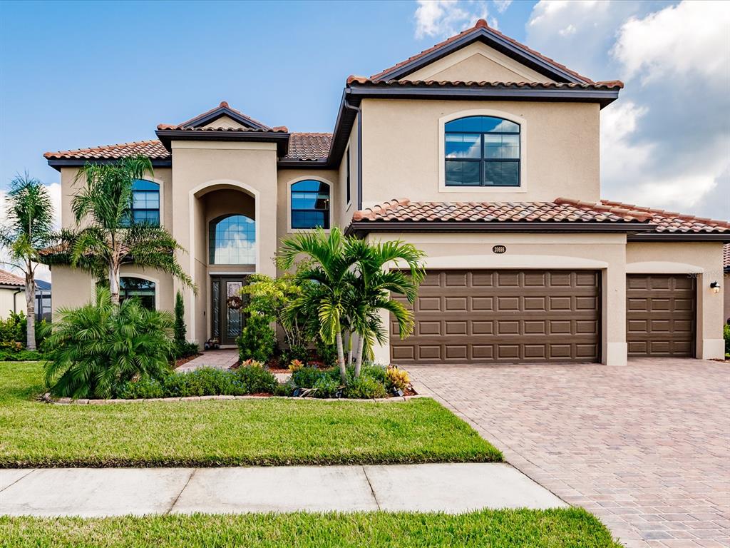 a front view of a house with a yard and garage