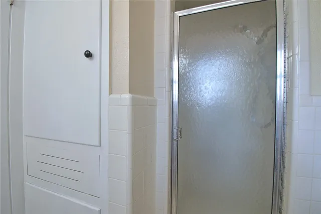 a bathroom with a glass shower door