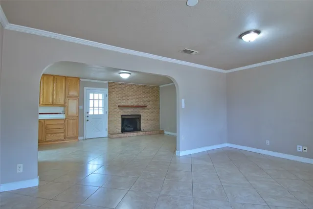 a view of a kitchen with a sink dishwasher and fireplace