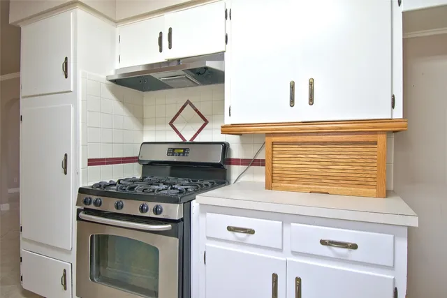 a view of small space with wooden floor and a window