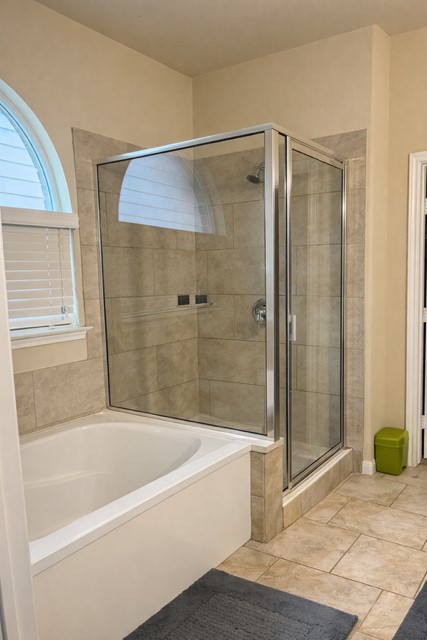11613 Reading Court Austin, TX 78717 - Photo 10 of 16 a bathroom with a bathtub and a shower