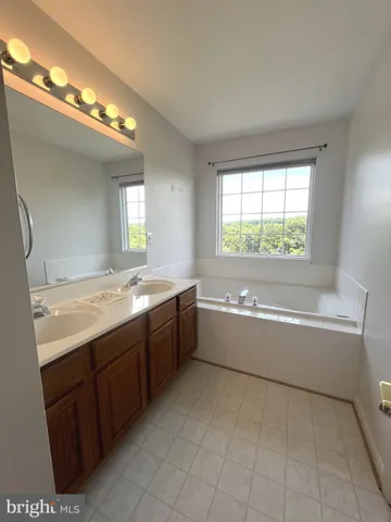 a large bathroom with a large tub and sink