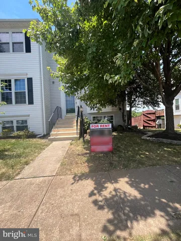 a wooden bench sitting in front of a house