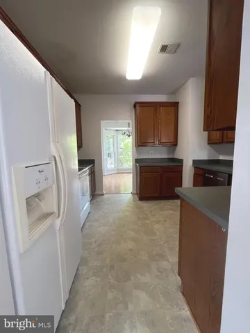 a kitchen with refrigerator sink and stove