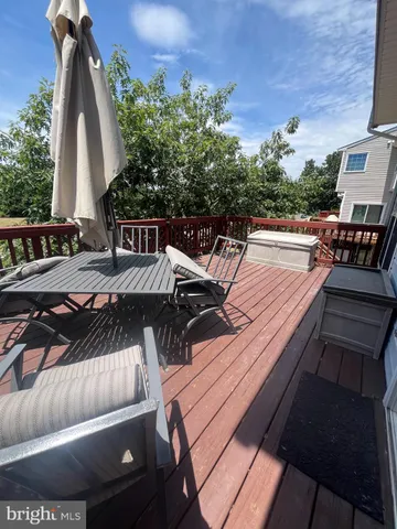 a view of a patio with couches table and chairs with wooden floor