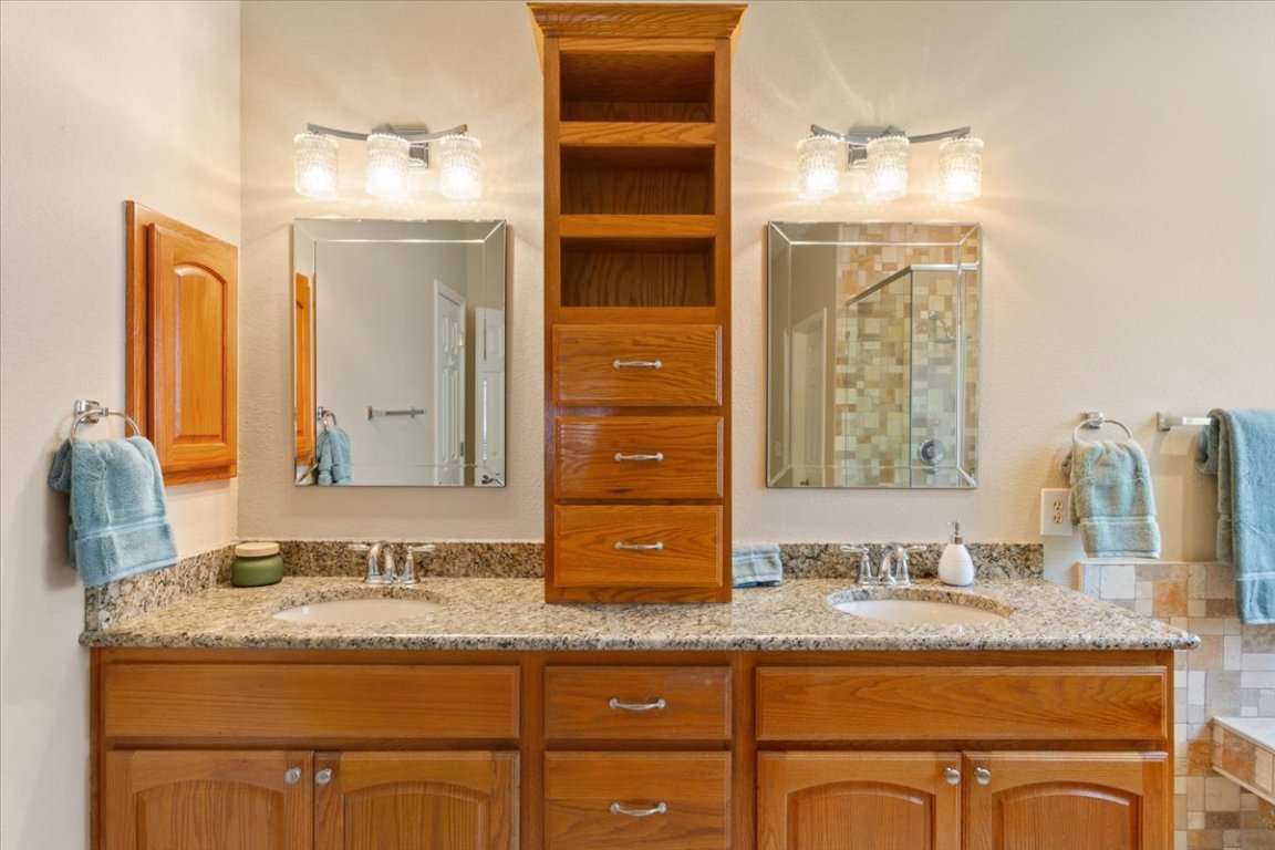 246 Red Poppy Trail Georgetown, TX 78633 - Photo 19 of 33 The primary bathroom has dual vanities and additional cabinetry for storage.