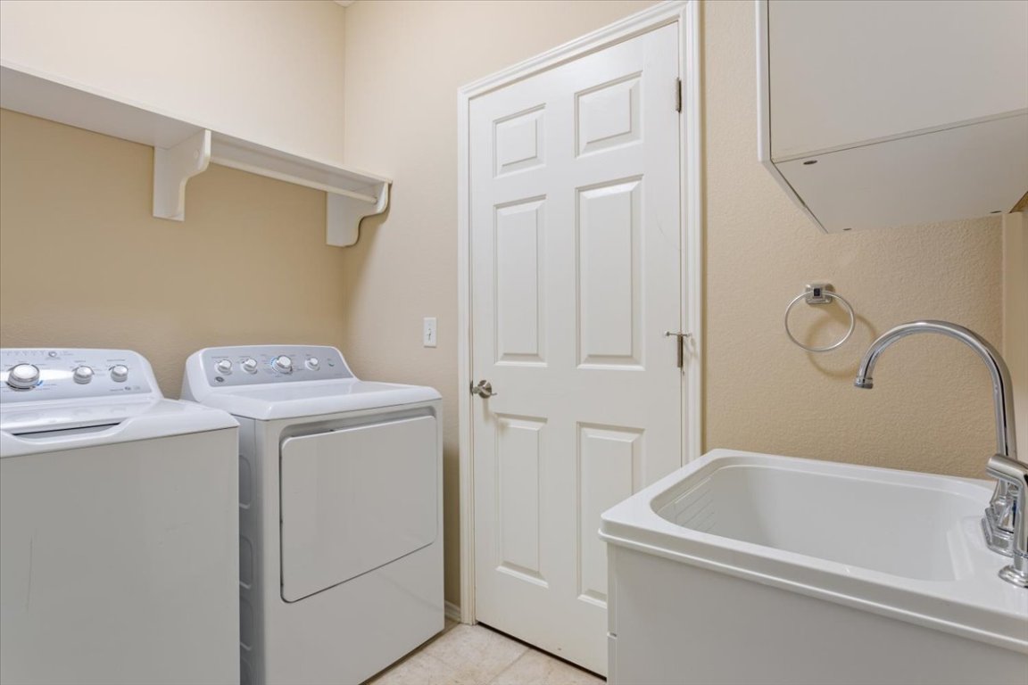 246 Red Poppy Trail Georgetown, TX 78633 - Photo 25 of 33 The laundry room is equipped with a convenient sink.