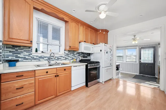a kitchen with cabinets appliances and a sink