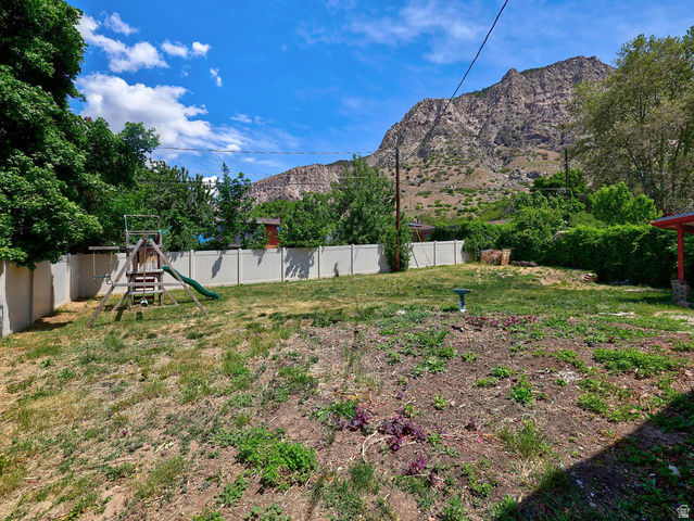 1272 Cook Street Ogden, UT 84404 - Photo 43 of 46 Expansive yard space featuring a partial privacy fence and mature trees