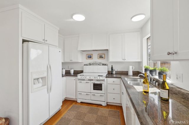 a view of a kitchen with appliances and cabinets