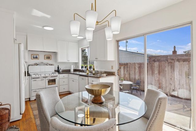 a kitchen with a dining table and chairs