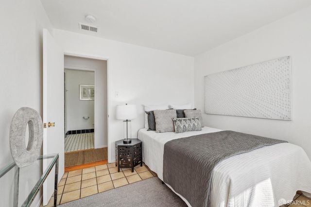 a bedroom with a bed and a mirror