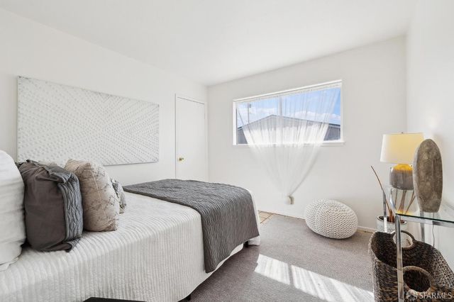 a bedroom with a bed and window