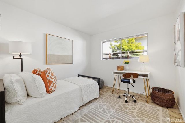 a bedroom with a bed and a desk