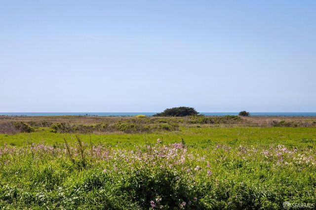 a view of an ocean and a mountain